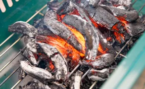 Burning charcoal in a grill